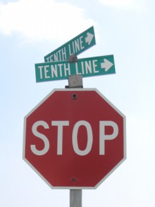 Photo of a stop sign with confusing street signs