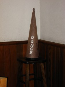 Photo of a dunce hat on a stool in a corner