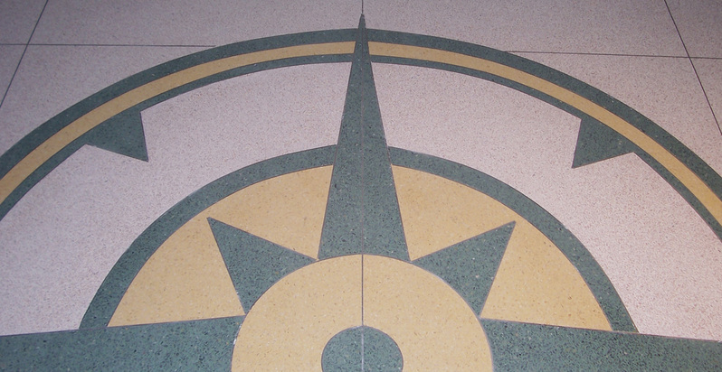 Photo of floor tiles colored to look like a decorative map compass