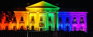 Photo of the White House lit with multicolored lights to form rainbow flag