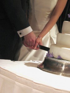 Photo of bride and groom cutting wedding cake