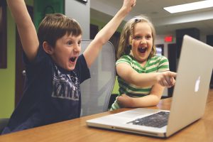 Photo of children playing on MacBook