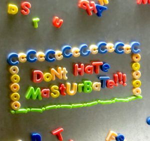 Photo of fridge magnets spelling "Don't hate masturbate"